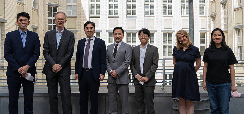 Dean of Faculty and Research Mark Hallerberg stands with four representatives of the KDI School from Sejong City, South Korea. Judith and Zhichun from the International Office stand to their right.
