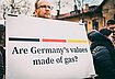 A protestor in support of Ukraine holds up a sign that reads "Are Germany's values made of gas?" in front of the German embassy in Vilnius.