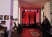 A small concert stage illumnated in red light at Prachtwerk, a live music bar and cafe in Berlin.