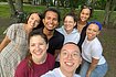 Selfie with a group of seven smiling Hertie School students and members of the Society of Hertie School for Inclusion, Equity, Liberty and Diversity. They are standing in a park with green grass, with two bicycles leaned up against the trees behind them.